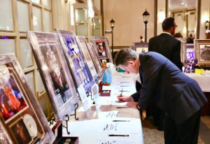 man putting in his bid at the silent auctions during the Front Steps Elevation Gala