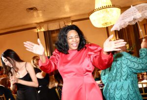 Woman enjoying the Front Steps Elevation Gala while dancing in Red