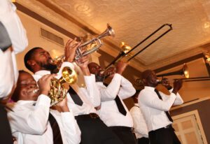 a band playing brass instruments at the Elevation Gala held by Front Steps